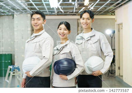 Portraits of young Japanese men and women standing at a construction site. Portraits of young Japanese men and women standing at a construction site. 142773587