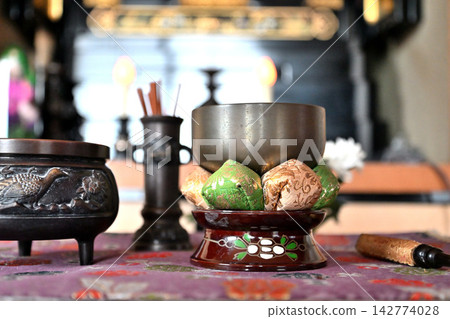 Buddhist bell, incense burner, and bell stick in front of the altar 142774028