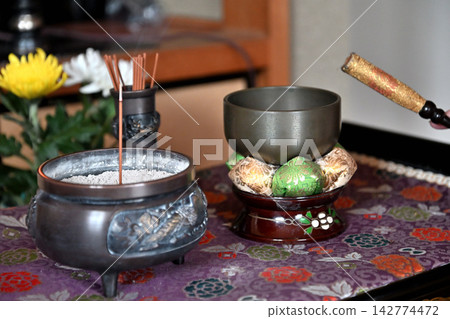 Senior hands striking the bell in front of the Buddhist altar Senior hands striking the bell in front of the Buddhist altar 142774472