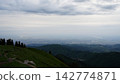 Scenic mountain view overlooking valley and cityscape under cloudy sky Scenic mountain view overlooking valley and cityscape under cloudy sky 142774871
