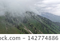 Mountain landscape with fog and greenery under cloudy sky Mountain landscape with fog and greenery under cloudy sky 142774886