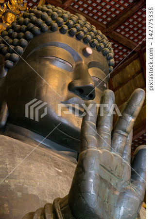 A view of the temple interior, overlooking the Great Buddha of Nara and its golden halo. A view of the temple interior, overlooking the Great Buddha of Nara and its golden halo. 142775338