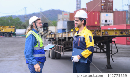 Industrial logistics supervisors discussing cargo shipment operations at freight warehouse Industrial logistics supervisors discussing cargo shipment operations at freight warehouse 142775839