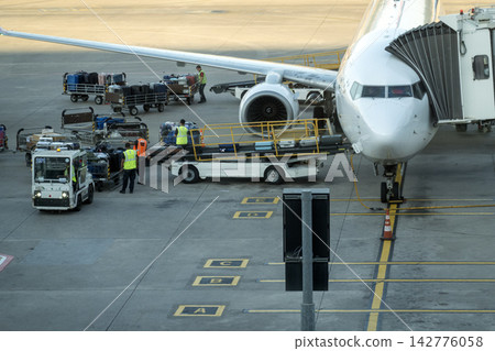 Baggage loading using a belt loader Baggage loading using a belt loader 142776058