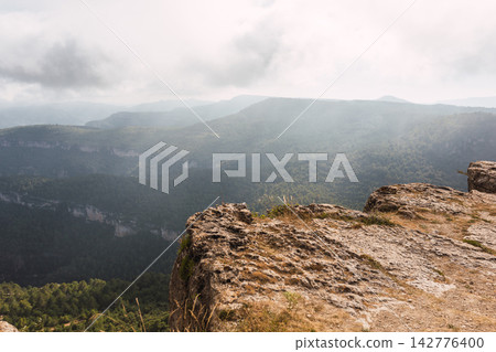 La Mussara cliff, Tarragona, overlooking other wooded mountains, summer La Mussara cliff, Tarragona, overlooking other wooded mountains, summer 142776400