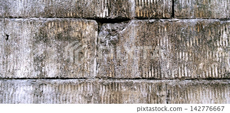 Weathered Concrete Block Wall with Vertical Texture 142776667