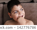 Child with intellectual disability looking away thoughtfully 142776786