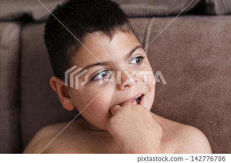 Child with intellectual disability looking away thoughtfully Child with intellectual disability looking away thoughtfully 142776786