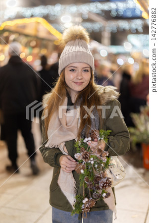 Young woman walking in the evening Christmas market Young woman walking in the evening Christmas market 142776882