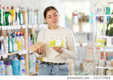 woman chooses clothespins for her home woman chooses clothespins for her home 142777068