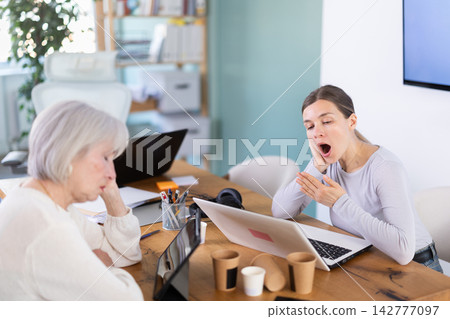 Tired women sleeps next to computer at work. Tired women sleeps next to computer at work. 142777097