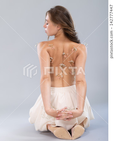 Sexy topless girl poses in studio. View from behind Sexy topless girl poses in studio. View from behind 142777447