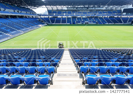 View of Nagasaki Stadium City's soccer-specific stadium, adjacent hotel, and spectator seating area. 142777541