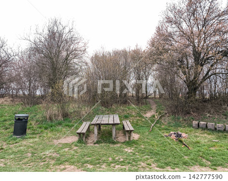 Wooden picnic table invites visitors to relax in nature near brandys nad labem Wooden picnic table invites visitors to relax in nature near brandys nad labem 142777590