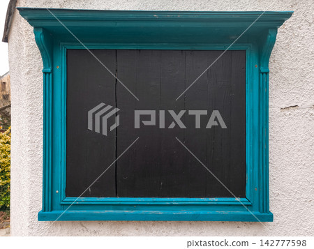 Empty black board with teal frame hanging on white wall in Jenstejn Empty black board with teal frame hanging on white wall in Jenstejn 142777598