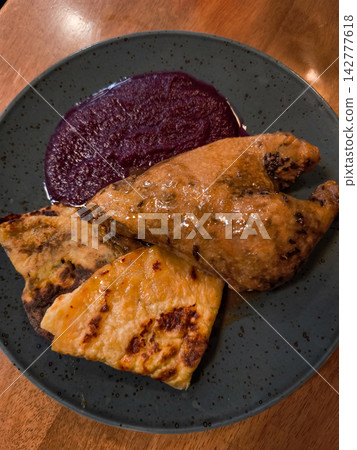 Roasted duck leg with potato pancakes and red cabbage in brandys nad labem restaurant 142777618