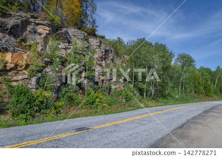Scenic asphalt highway running along rocky cliff Scenic asphalt highway running along rocky cliff 142778271