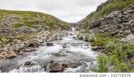 waterfall in the mountains waterfall in the mountains 142778376
