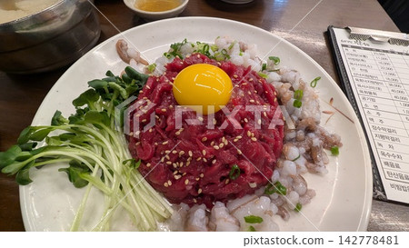 Korean dishes of yukhoe (Korean beef tartare) and long-armed octopus eaten at Gwangjang Market Korean dishes of yukhoe (Korean beef tartare) and long-armed octopus eaten at Gwangjang Market 142778481