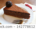 Decadent Slice of Chocolate Cake Dusted with Cocoa Powder 142778612