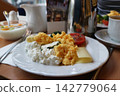 Hotel Breakfast Plate with Scrambled Eggs and Cottage Cheese 142779064