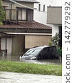 Cars submerged in water due to road flooding caused by heavy rain. 142779292