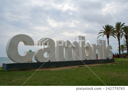 Cambrils, Spain, August 27 2017: Large Cambrils city sign at the promenade with palm trees Cambrils, Spain, August 27 2017: Large Cambrils city sign at the promenade with palm trees 142779765