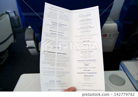 Warsaw, Poland, May 10 2018: Premium economy inflight menu on a flight to the USA Warsaw, Poland, May 10 2018: Premium economy inflight menu on a flight to the USA 142779782