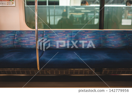 Blue seats inside the train Blue seats inside the train 142779956