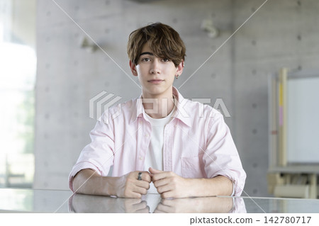 A young foreign man looking directly at the camera 142780717