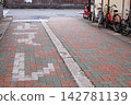 Stop signs on interlocking paving and bicycles 142781139