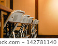 Neatly arranged folding chairs 142781140