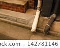 Old drainage pipes placed on the wall of the building 142781146