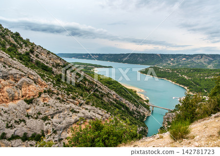 The lake Lac de Sainte-Croix in France has clear cyan water. The Verdon River flows from the Verdon Canyon into the lake The lake Lac de Sainte-Croix in France has clear cyan water. The Verdon River flows from the Verdon Canyon into the lake 142781723