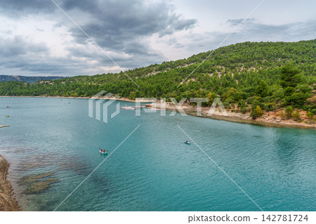 The lake Lac de Sainte-Croix in France has clear cyan water. The Verdon River flows from the Verdon Canyon into the lake 142781724