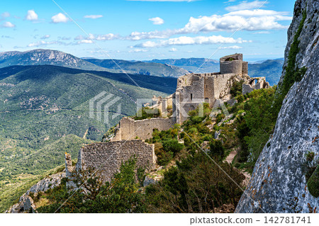 The Cathar medieval castle of Peyrepertuse in the Aude department, southern France situated in the French Pyrenees The Cathar medieval castle of Peyrepertuse in the Aude department, southern France situated in the French Pyrenees 142781741