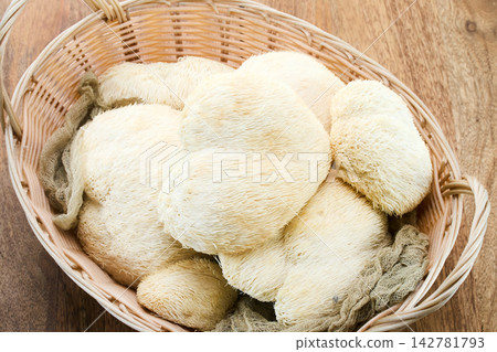 Lion's mane mushrooms in basket on wooden background Lion's mane mushrooms in basket on wooden background 142781793