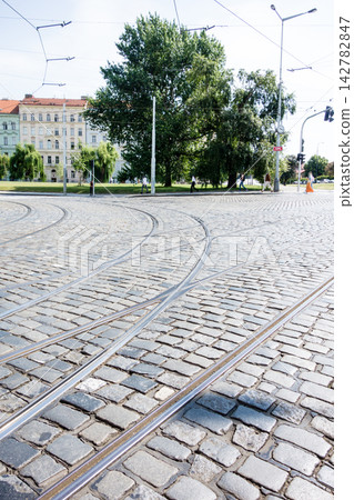 鵝卵石街道上鋪設著電車軌道——這是捷克共和國首都布拉格的城市景觀。 鵝卵石街道上鋪設著電車軌道——這是捷克共和國首都布拉格的城市景觀。 142782847