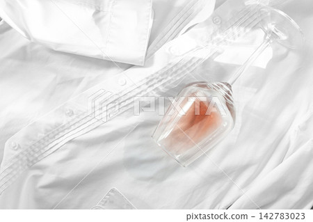 Glass, with pink wine, spilled on a white shirt, close-up, selective focus, no people, concept, top view, Glass, with pink wine, spilled on a white shirt, close-up, selective focus, no people, concept, top view, 142783023