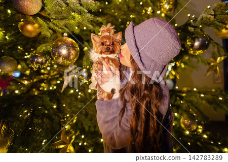 happy girl near a decorated New Year's tree happy girl near a decorated New Year's tree 142783289