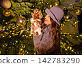 happy girl near a decorated New Year's tree 142783290