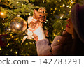 happy girl near a decorated New Year's tree 142783291