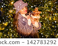 happy girl near a decorated New Year's tree 142783292