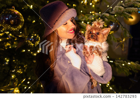 happy girl near a decorated New Year's tree happy girl near a decorated New Year's tree 142783293