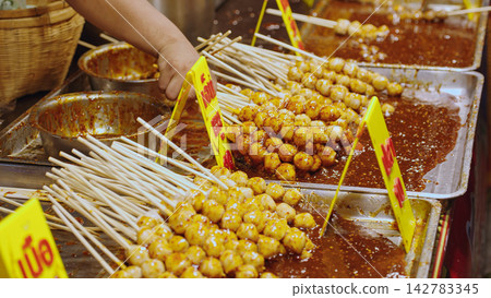 Street Food Seller At Night Market Stall, Food Sales, Local Market Trading And Asian Street Food Vendor Concept Street Food Seller At Night Market Stall, Food Sales, Local Market Trading And Asian Street Food Vendor Concept 142783345