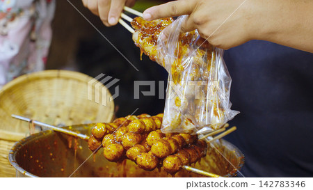 Street Food Sale At Night Market Stall, Local Market Trading And Asian Food Vendor Concept Street Food Sale At Night Market Stall, Local Market Trading And Asian Food Vendor Concept 142783346