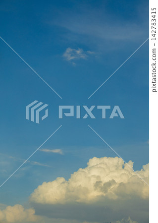 Vast blue sky with fluffy white cumulus clouds on a sunny day Vast blue sky with fluffy white cumulus clouds on a sunny day 142783415