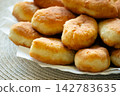 Golden fried pirozhki pies stacked on plate for bakery menu 142783635