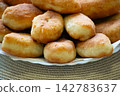 Golden fried pirozhki pies stacked on plate for bakery menu 142783637