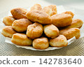 Stack of golden fried pirozhki pies served on plate for bakery design 142783640